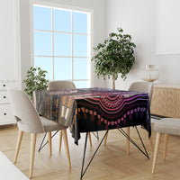 Patterned tablecloth on dining table with purple, black, and pink ornament prints.