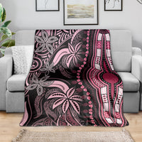 Pink and dark plum dashiki-style blanket spread on a sofa with decorative border