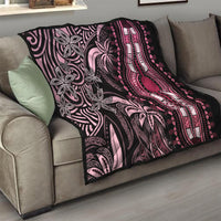 Pink and black dashiki quilt on sofa with floral vines, beads, and central hand medallion