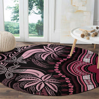 Round carpet rug with bold tribal mandala pattern in black and pink tones