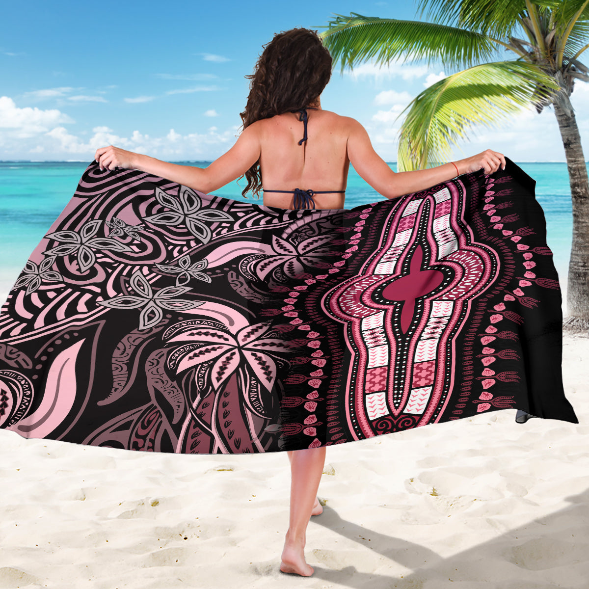 Pink and black dashiki sarong draped across back, featuring a large central cross motif