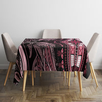 Round tablecloth with dark and pink ornate print, draped over dining table