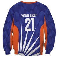 Blue sweatshirt back with YOUR TEXT 21 print and orange side panels with flag rays