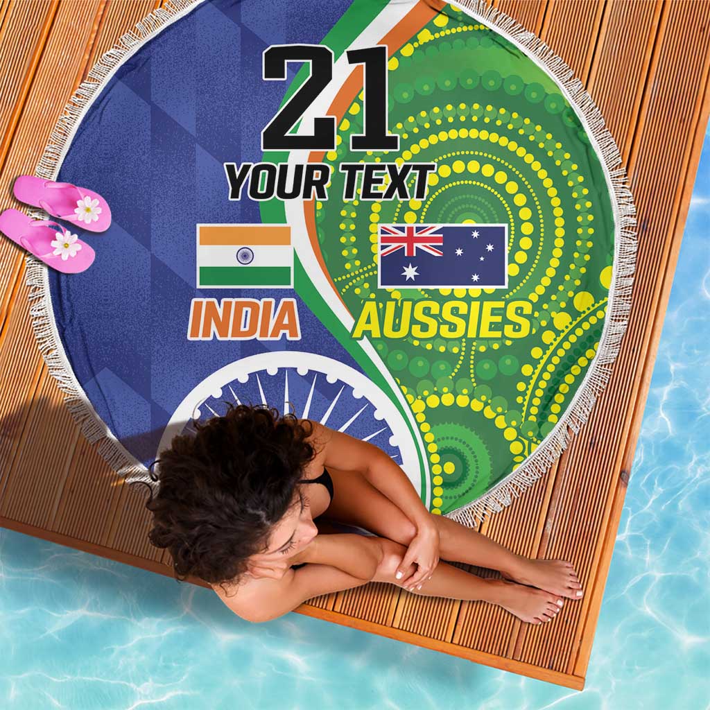 Round beach blanket with white fringe and India–Aussies flags graphic on blue-green fabric.