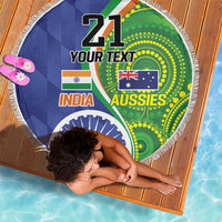 Round beach blanket with white fringe and India–Aussies flags graphic on blue-green fabric.