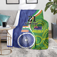 Custom cricket blanket draped on floor, blue-green “21” design with India and Aussies logos