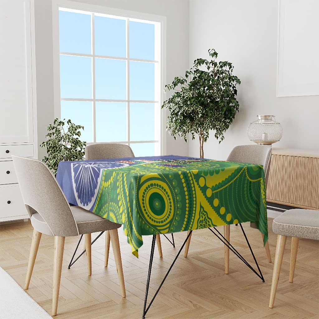 Blue-green tablecloth draped over dining table with flag and circle pattern