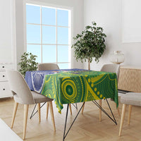 Blue-green tablecloth draped over dining table with flag and circle pattern