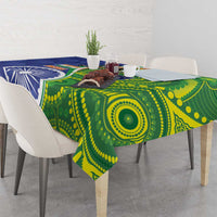 Blue-green tablecloth with large circular motif and blue emblem