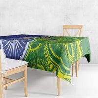 Blue-green tablecloth draped across table edge with circular pattern