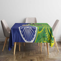 Blue-green tablecloth on square table with emblem and green dot circle pattern