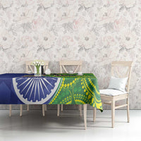 Blue-green tablecloth on dining table with blue emblem and green dot pattern