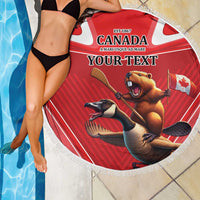 Round red Canada beach blanket with fringe, beaver and bird graphic, “YOUR TEXT” on person.