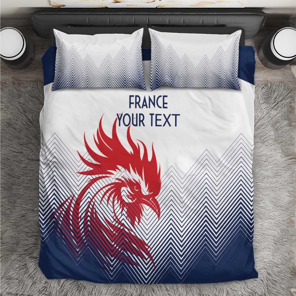 White, navy bedding set with France text, red rooster graphic, and zigzag pillowcases