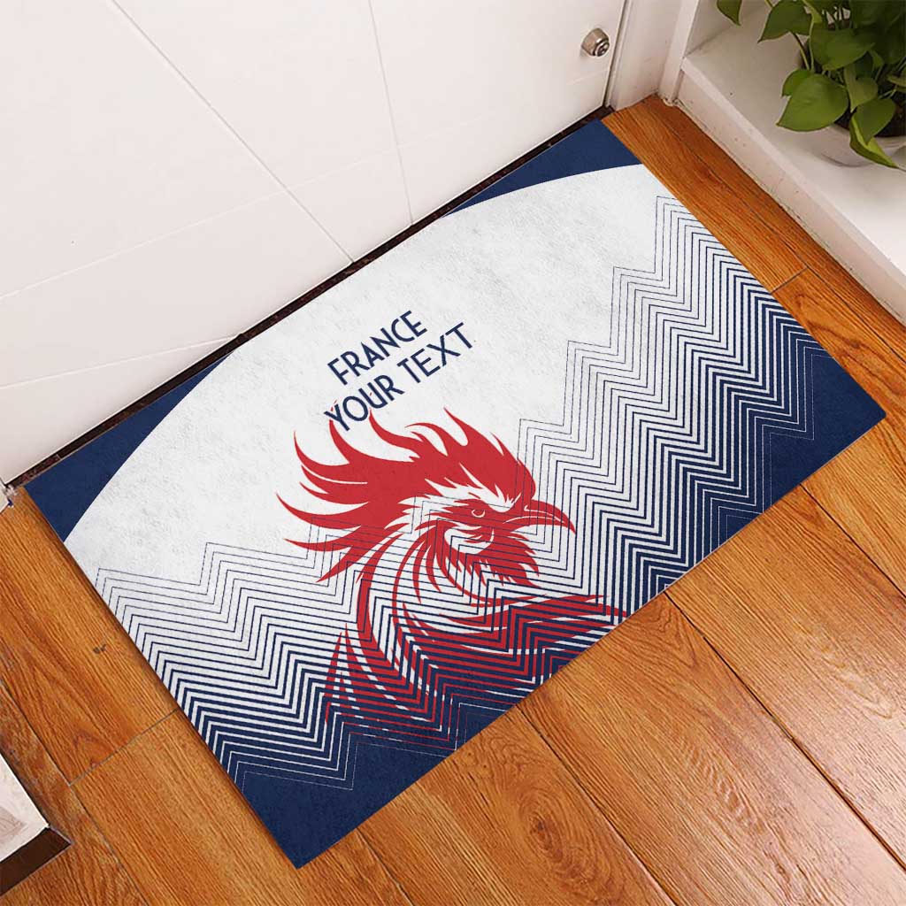 Rubber doormat in white and navy featuring a red rooster, zigzag pattern, and 'FRANCE YOUR TEXT'.