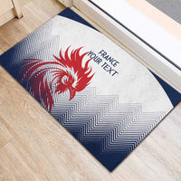 White and navy rubber doormat with red rooster graphic, zigzag pattern, and 'FRANCE YOUR TEXT'.