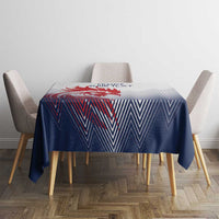 Blue and white chevron tablecloth covering round table with gray chairs