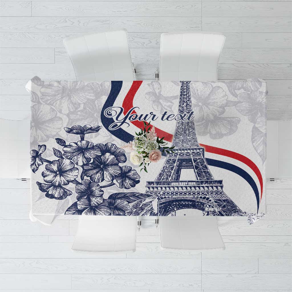 White tablecloth with Eiffel Tower graphic and blue floral leaf pattern
