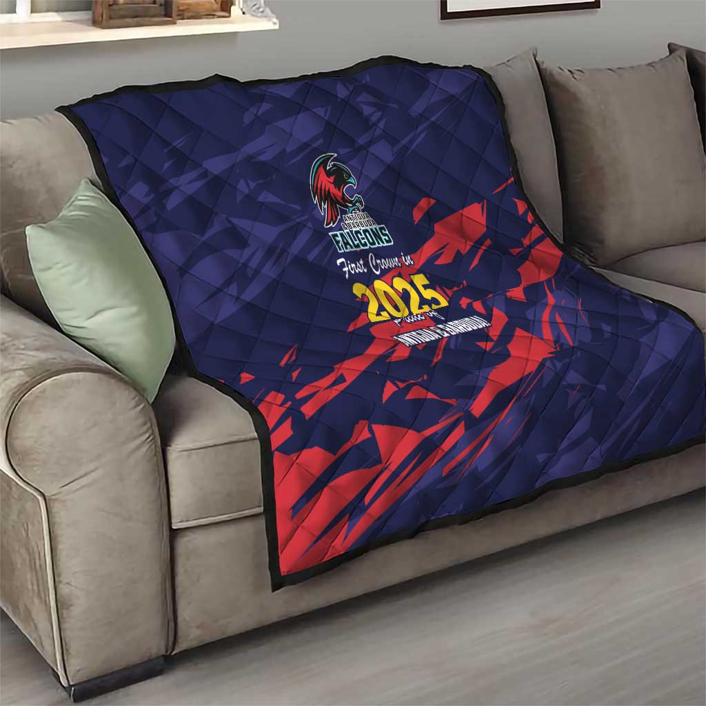 Navy quilt draped on sofa with red pattern, Falcons crest and 2025 center print