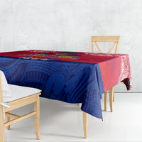Red and blue patterned tablecloth with Polynesian motifs, covering table top