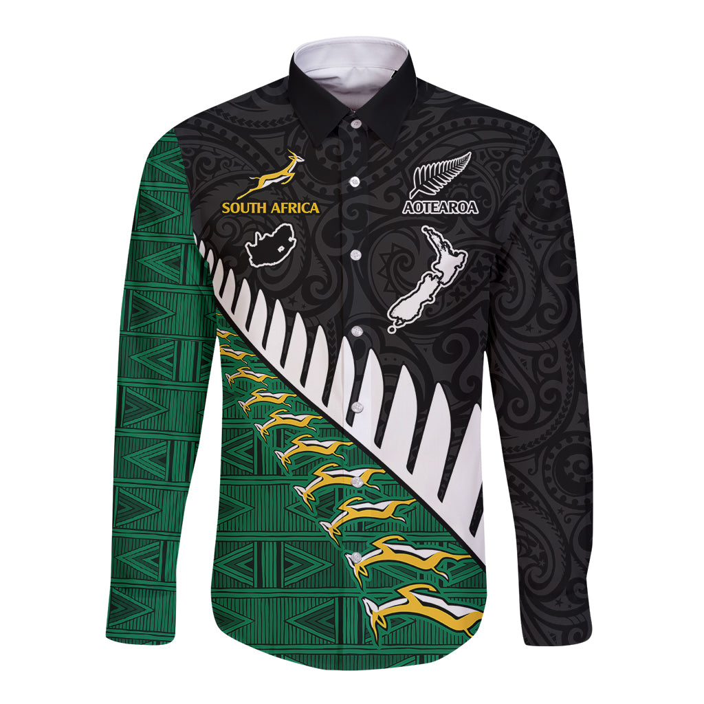 Black long-sleeve rugby button shirt with green panel, animal emblems and patterned graphics