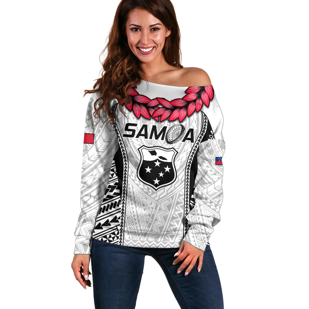 White off-shoulder rugby sweater with tribal print, pink flower detail, SAMOA emblem.