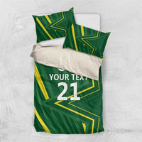 Green bedding set with two pillowcases and duvet featuring yellow geometric pattern