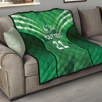 Green quilt blanket draped on couch, jersey stripes, 'YOUR TEXT' and number 21