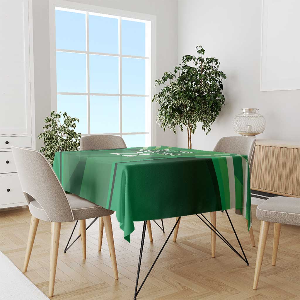 Green tablecloth with sporty stripe pattern, draped over a dining table.