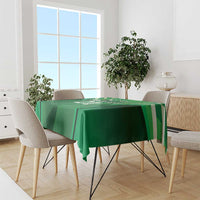 Green tablecloth with sporty stripe pattern, draped over a dining table.