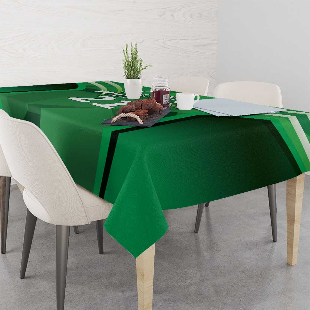 Green tablecloth with sporty graphic stripes, covering a rectangular dining table.