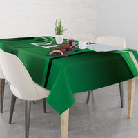 Green tablecloth with sporty graphic stripes, covering a rectangular dining table.