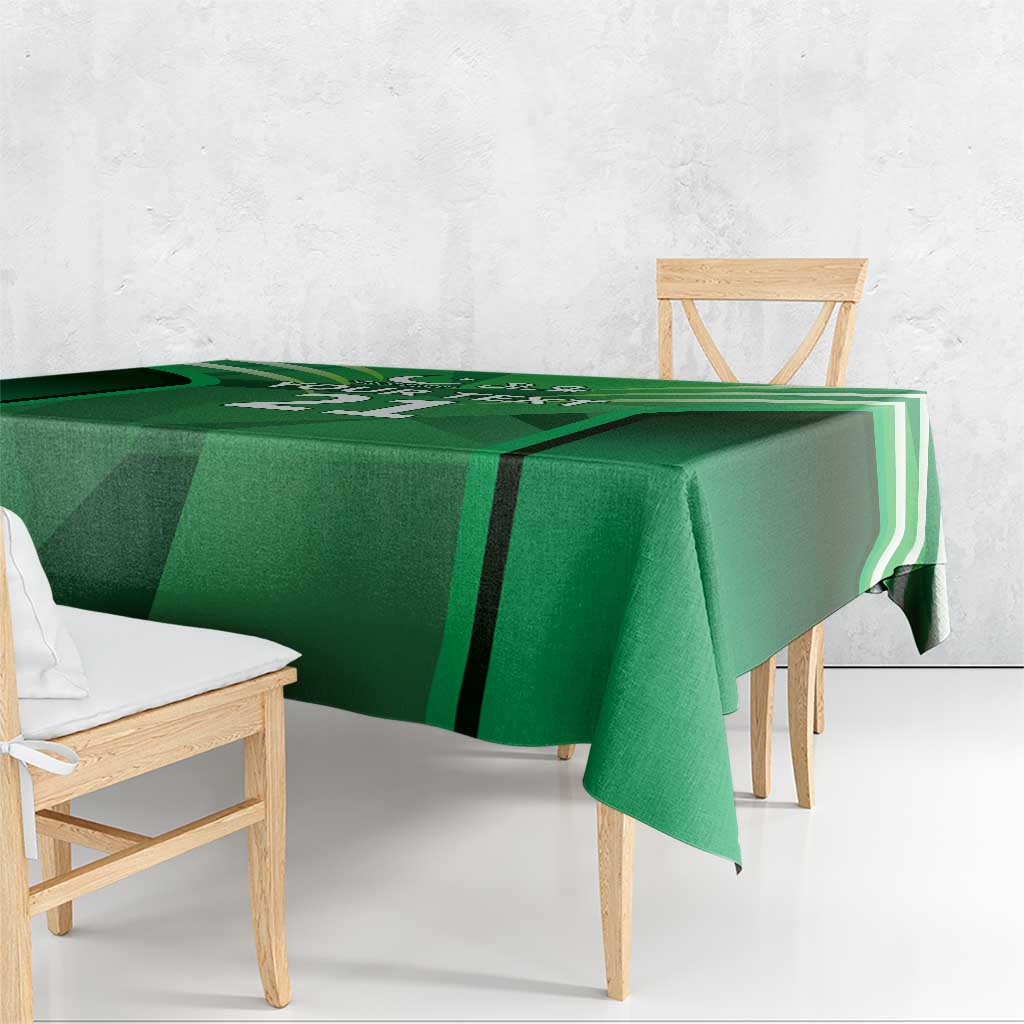 Green tablecloth with black and white geometric accents and corner drape.