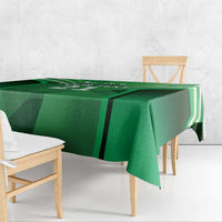 Green tablecloth with black and white geometric accents and corner drape.