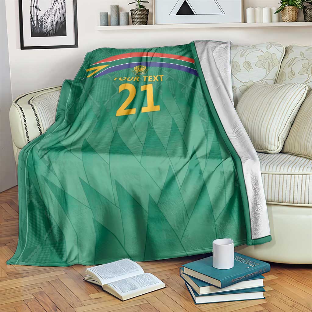 Green cricket blanket with flag stripes, Proteas crest, and 'YOUR TEXT 21'.