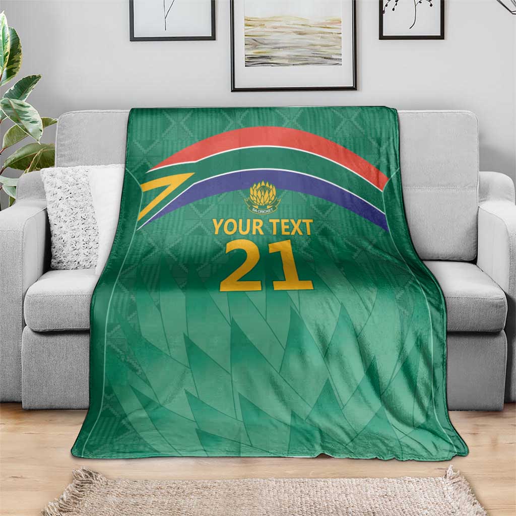 Green cricket blanket with flag stripes, Proteas crest, and 'YOUR TEXT 21' design.