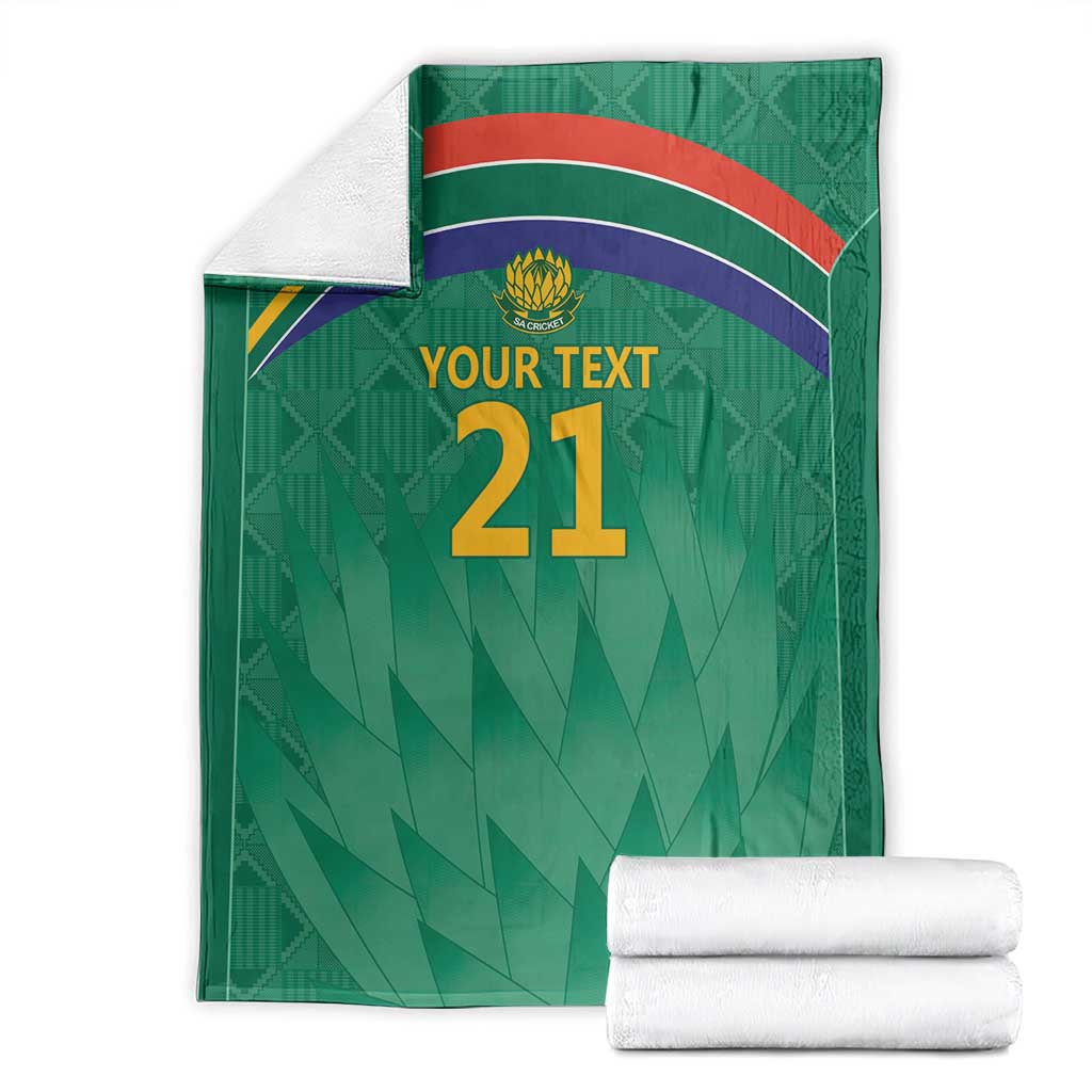 Front view of green cricket blanket with flag stripes, Proteas crest, and 'YOUR TEXT 21'.