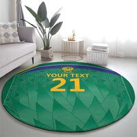 Green circular cricket carpet with purple trim and gold '21' numeral
