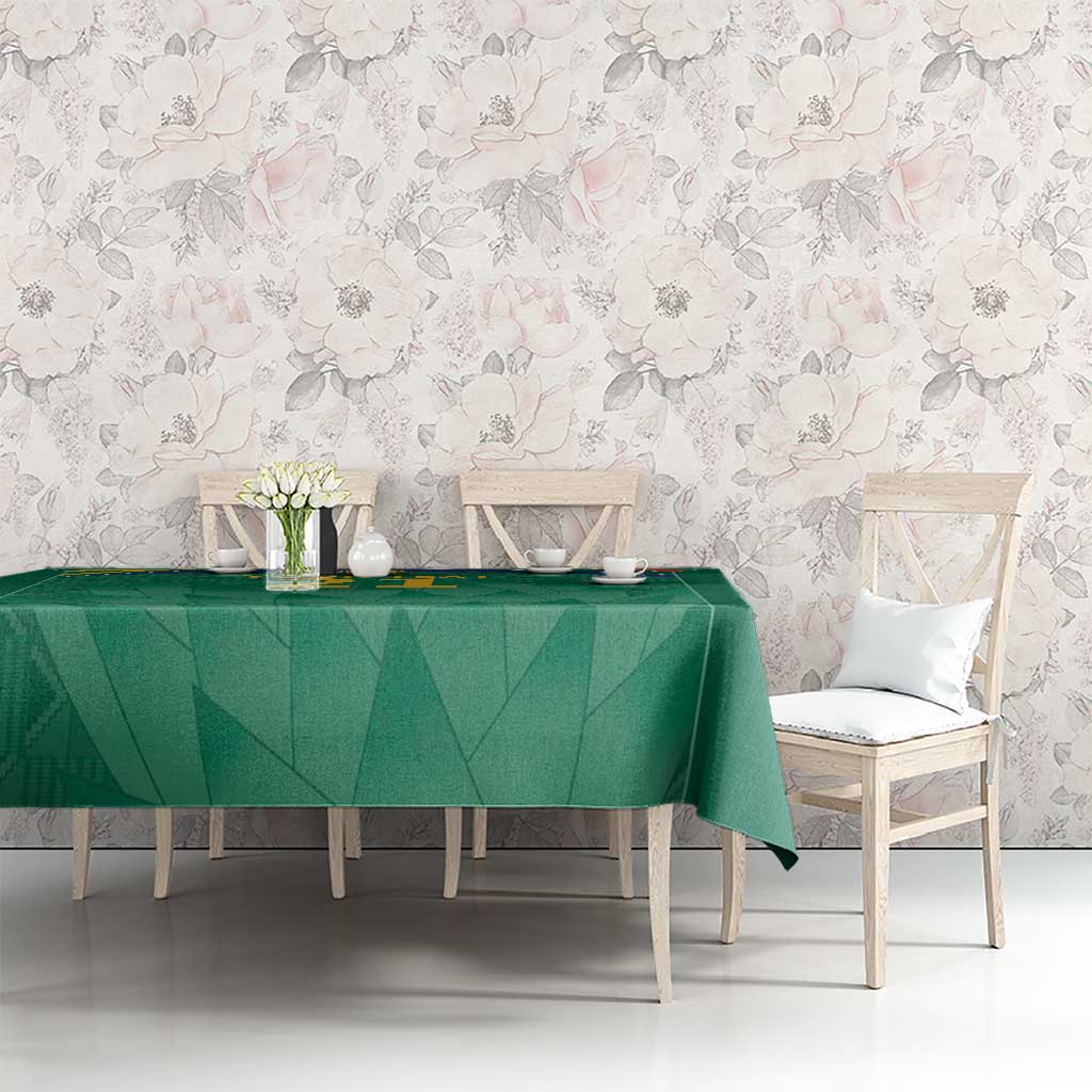 Green cricket tablecloth on long dining table with repeating geometric pattern