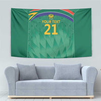 Green cricket tapestry with Proteas crest, rainbow arc, and “YOUR TEXT 21” on wall