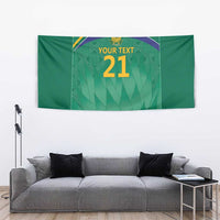 Green tapestry showing Proteas crest, rainbow arc, and “YOUR TEXT 21” above sofa