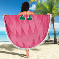 Pink round beach blanket with fringe, crest logo, and large “YOUR TEXT” number 21