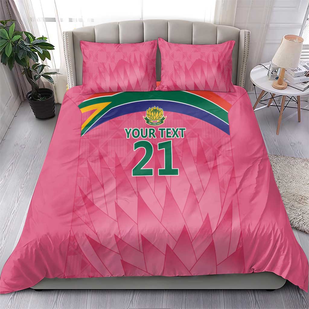 Pink bedding set with 'YOUR TEXT 21' graphic on duvet and two matching pillows