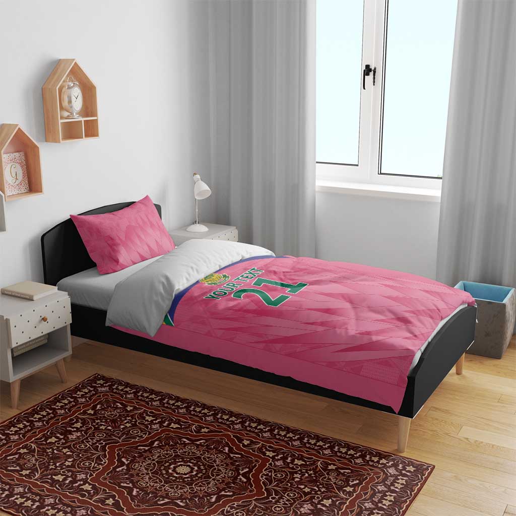 Pink bedding set with 'YOUR TEXT 21' graphic on duvet and two pink pillows
