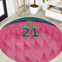 Pink round carpet with green border and '21' center graphic