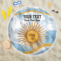 Round light blue beach blanket with fringe, sun face graphic and bold text.
