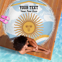 Round light blue beach blanket with fringe, sun face graphic and custom text, flat.