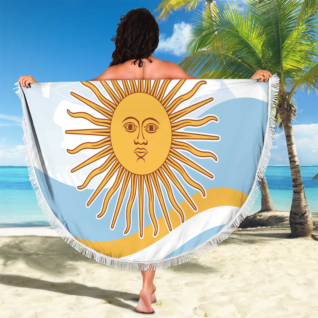Round light blue beach blanket with fringe, sun face graphic and text, draped outdoors.