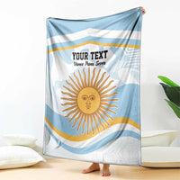 Light blue and white rugby blanket, draped view, with custom text and sun illustration