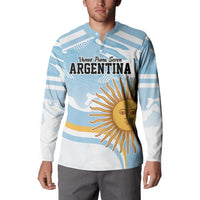 Light blue and white striped rugby-style button sweatshirt on model, Argentina sun graphic